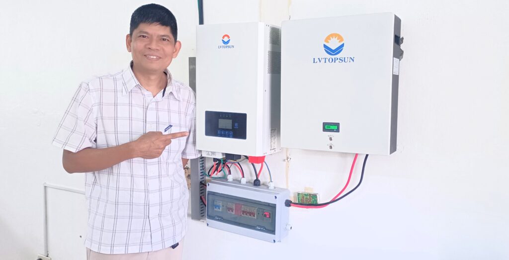 (GAiN PH Director Rod Santos with the newly installed technology that provides electricity to the school)